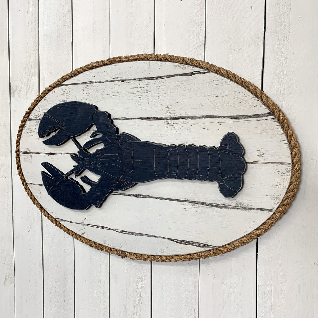Dockside Lobster Plaque in Atlantic Navy Blue finish. Nautical wall decor featuring a carved wood lobster on white barnboard with rope trim