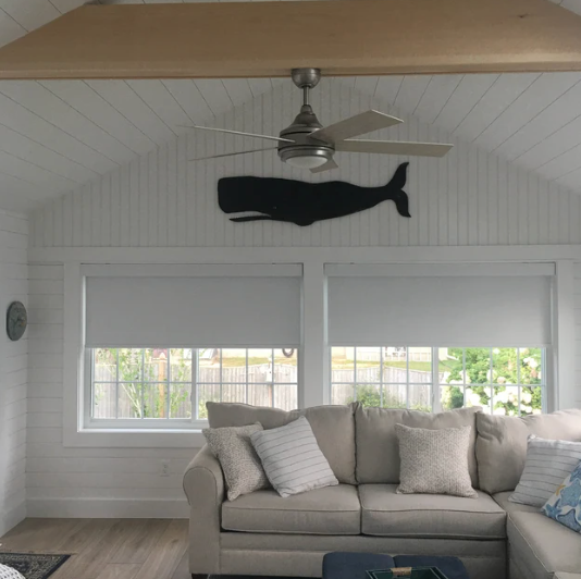 Black wooden whale wall art nautical decor in beach house sun room coastal living room by Haven America