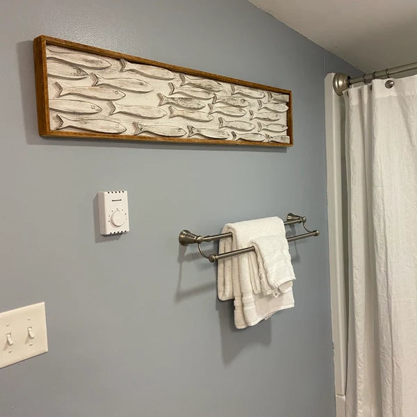 Bathroom with 41" size framed minnow school wall art