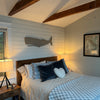 driftwood grey whale artwork placed over bed