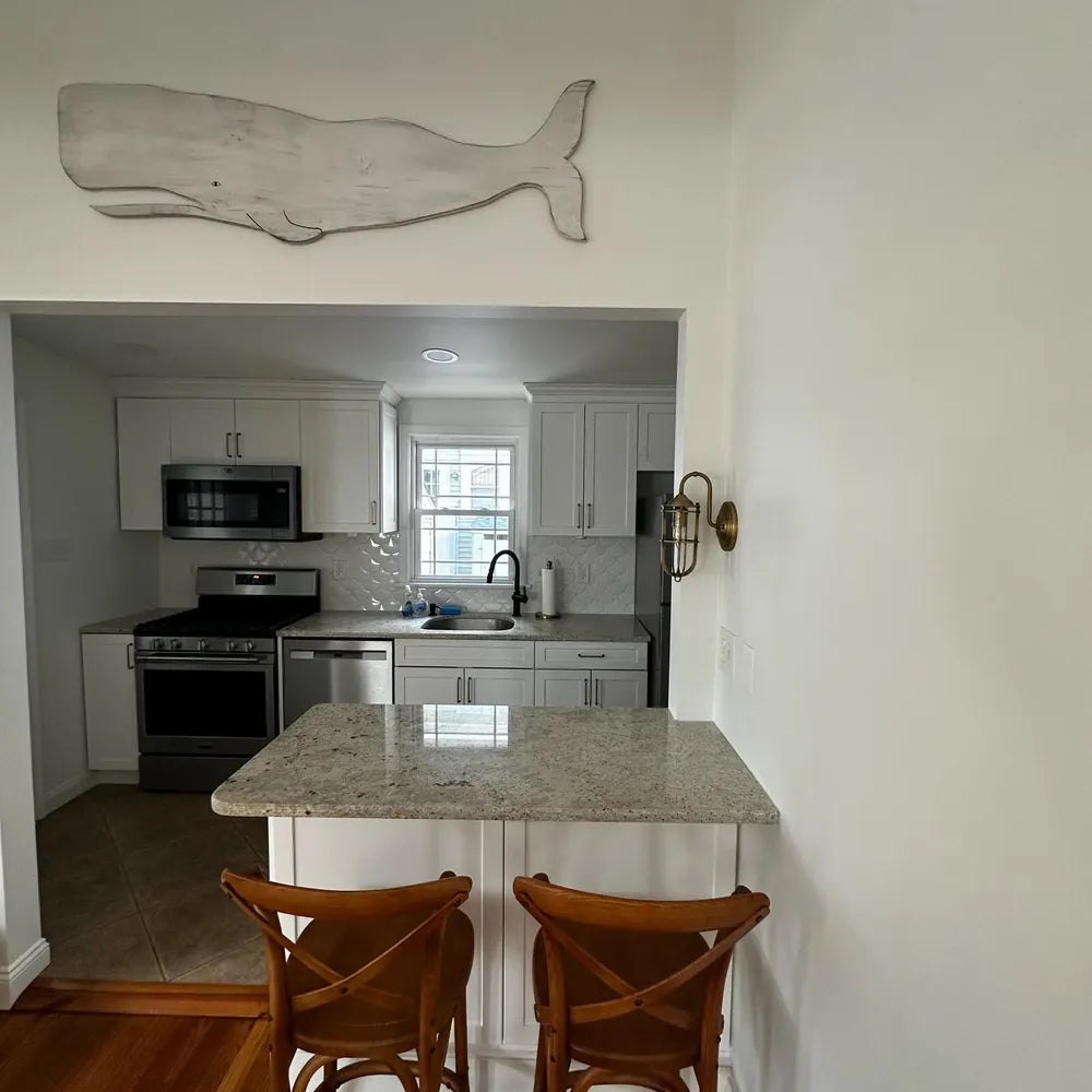 white folk whale placed over a kitchen island bar