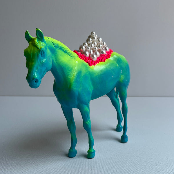 blue horse with yellow paint 