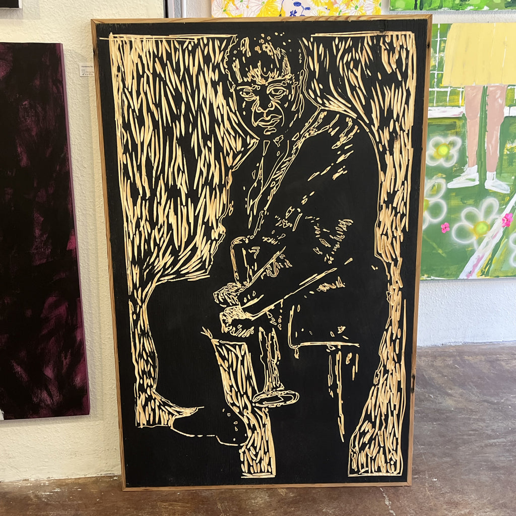 New Orleans legend Louis Armstrong sitting on floor of Gallery Haven in the French Quarter of New Orleans.